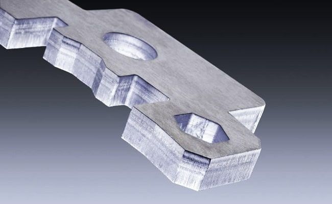 Laser-cut part with exact curves and tight radii.
