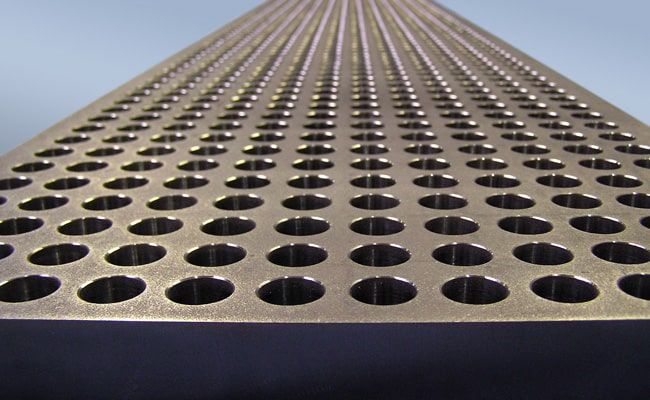 Heat exchanger tube sheet with more than 1200 bores Ø 25.55 mm, tolerance ±0.05 mm, outer contour waterjet-cut.