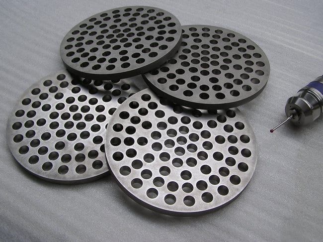 Heat exchanger tube sheets made of 1.4571 (V4A), outer contour waterjet-cut.