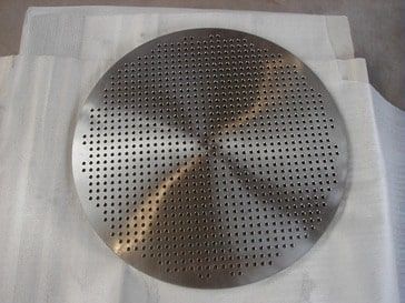 Heat exchanger sheet made of 1.4841, Ø 1550 mm, 65 mm thick, with small bores Ø 9.5 mm CNC-drilled.